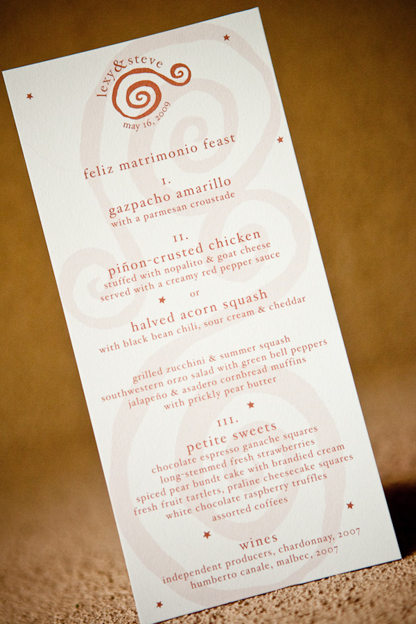 image of a white reception menu with orange font and whimsical designs - photo by New Mexico based wedding photographers Twin Lens